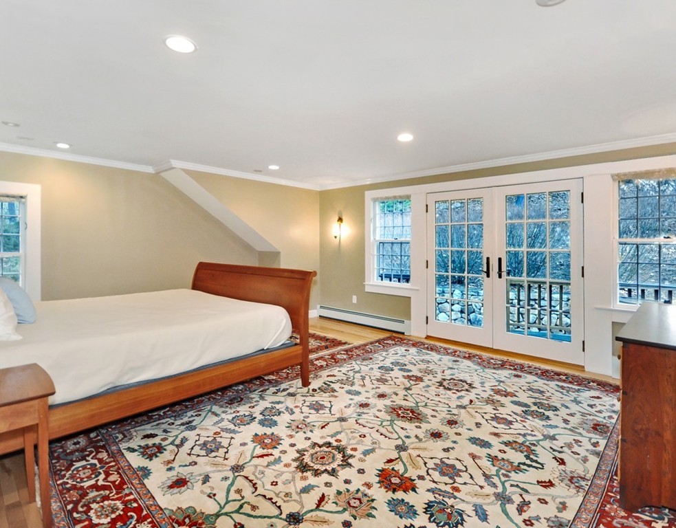 24 Ridge Road Concord, MA 01742 - Photo 8 of 25 a bedroom with a bed and glass window