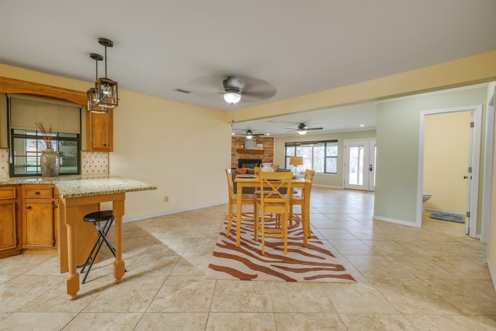103 Arrow Point Abilene, TX 79601 - Photo 13 of 40 a dining room with furniture a window and kitchen view