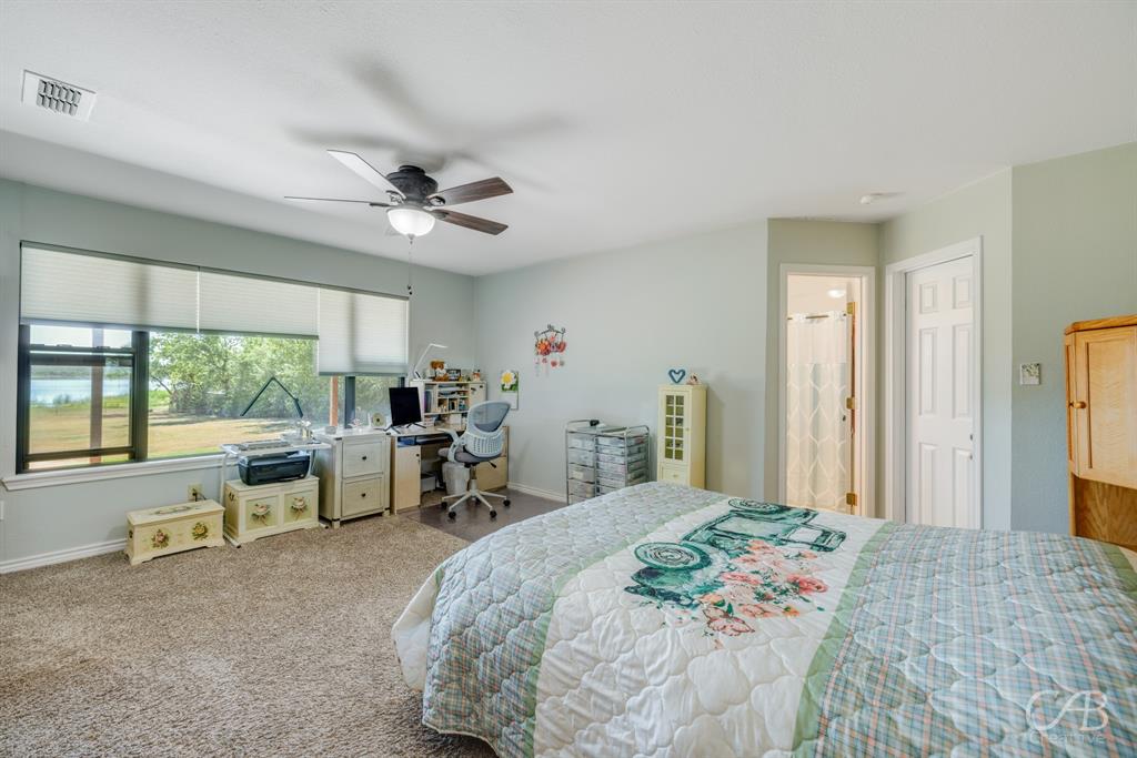 103 Arrow Point Abilene, TX 79601 - Photo 20 of 40 a bed room with a bed and a large window