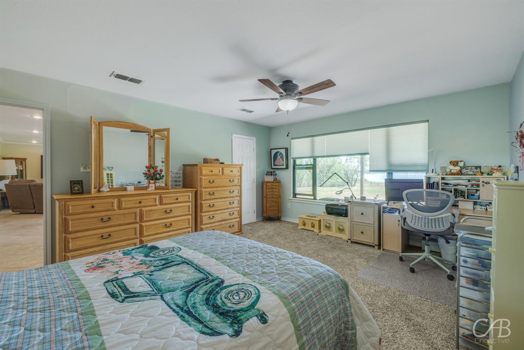 103 Arrow Point Abilene, TX 79601 - Photo 23 of 40 a bed room with a bed window and dresser