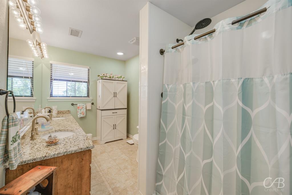 103 Arrow Point Abilene, TX 79601 - Photo 24 of 40 a kitchen with a sink refrigerator and cabinets