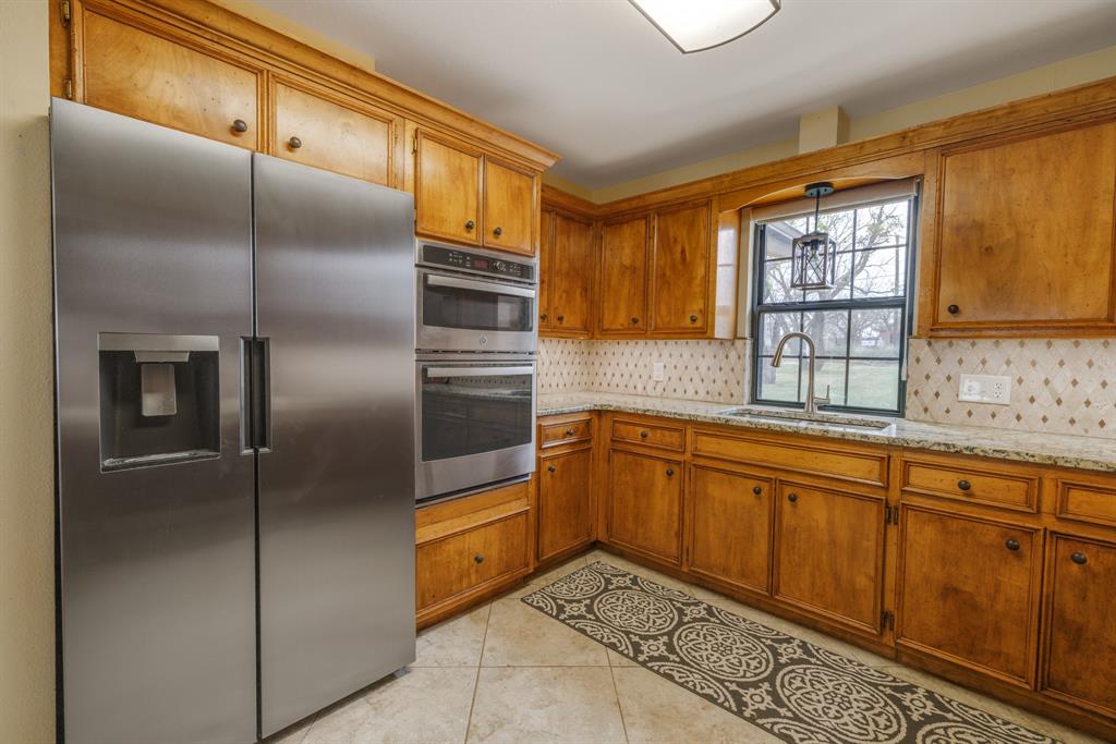 103 Arrow Point Abilene, TX 79601 - Photo 4 of 40 a kitchen with stainless steel appliances granite countertop a refrigerator and a sink