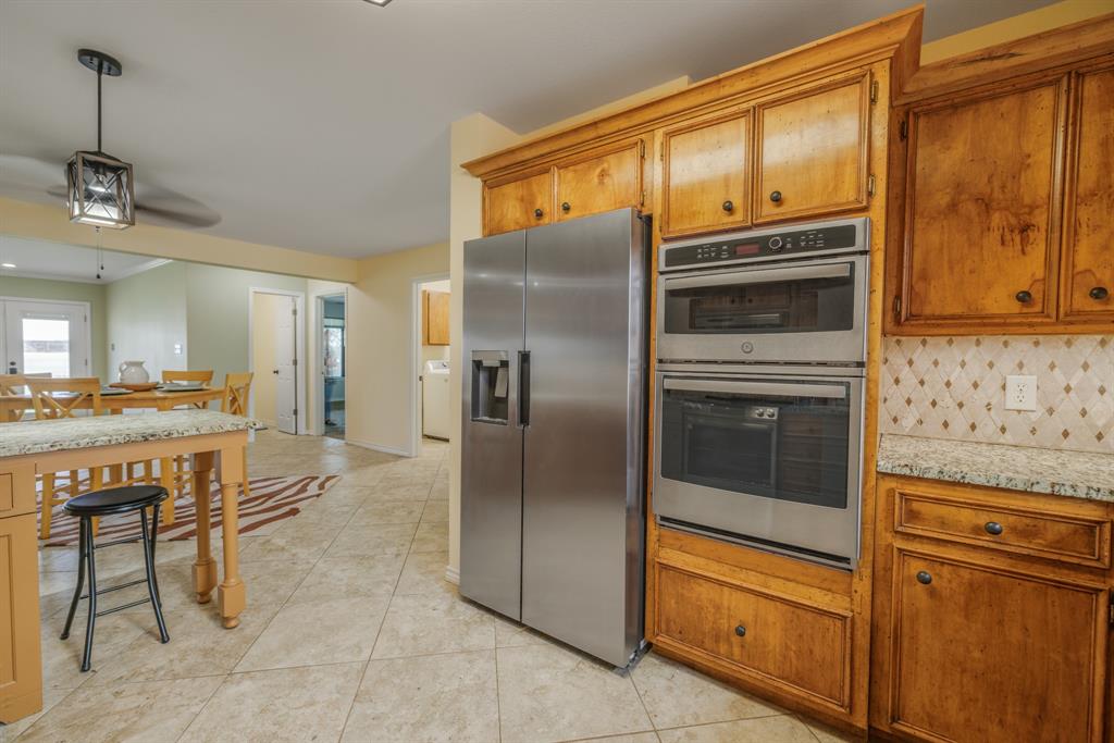 103 Arrow Point Abilene, TX 79601 - Photo 5 of 40 a kitchen with stainless steel appliances granite countertop a refrigerator and a stove top oven