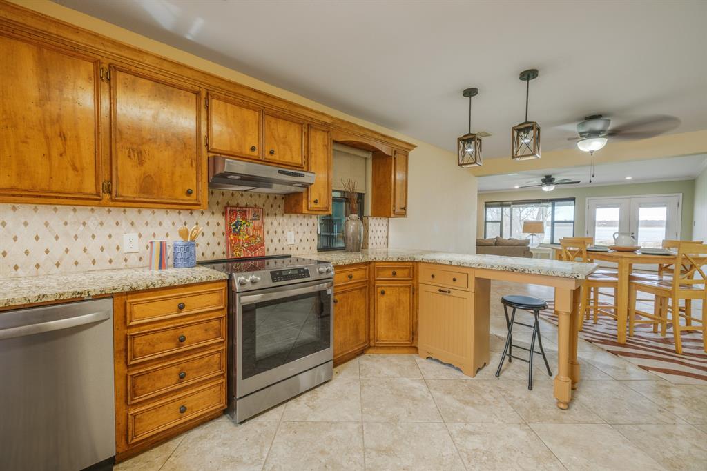 103 Arrow Point Abilene, TX 79601 - Photo 6 of 40 a kitchen with stainless steel appliances granite countertop a sink counter space and cabinets