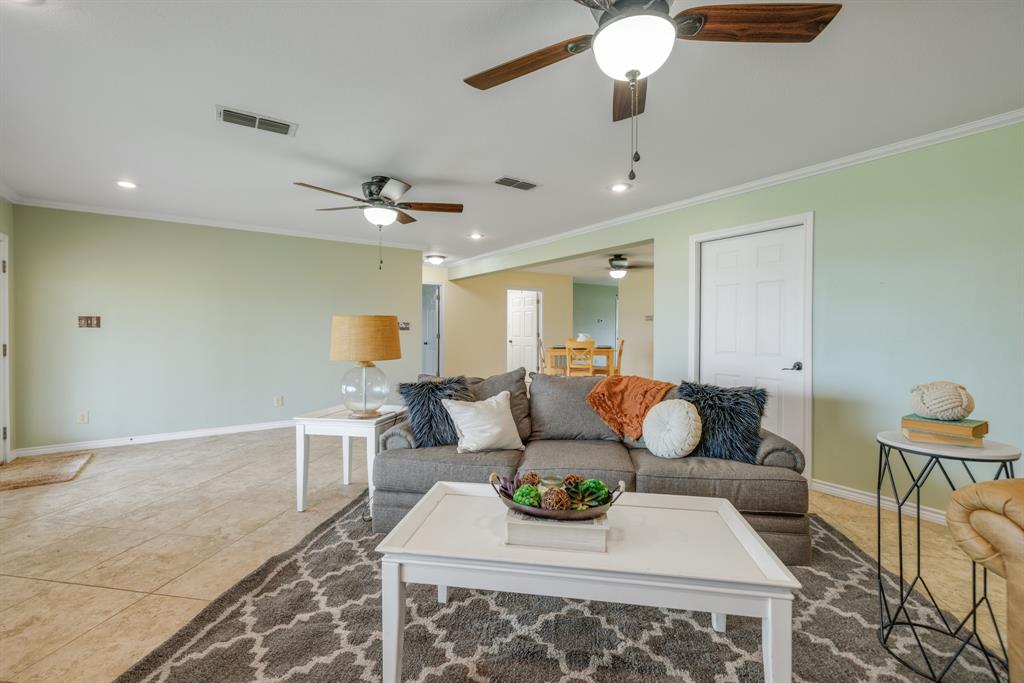 103 Arrow Point Abilene, TX 79601 - Photo 7 of 40 a living room with furniture and a chandelier