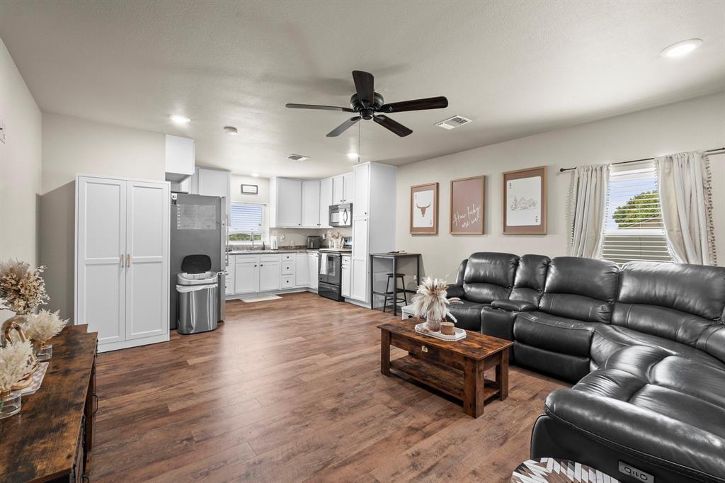 1404 McConnell Road Gunter, TX 75058 - Photo 11 of 27 a living room with furniture and a kitchen view