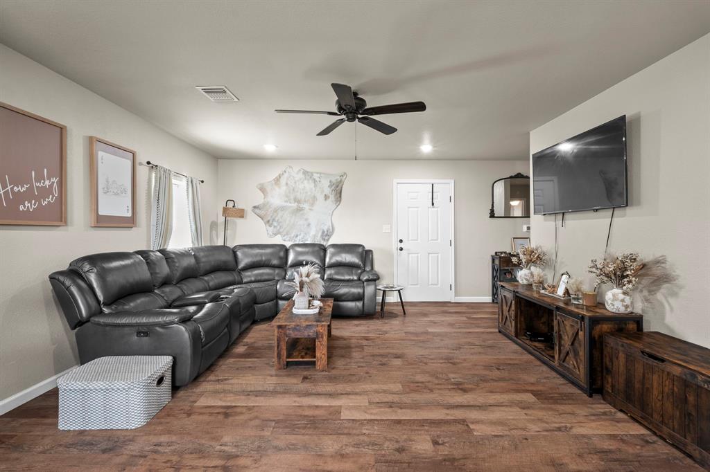 1404 McConnell Road Gunter, TX 75058 - Photo 12 of 27 a living room with furniture and a flat screen tv