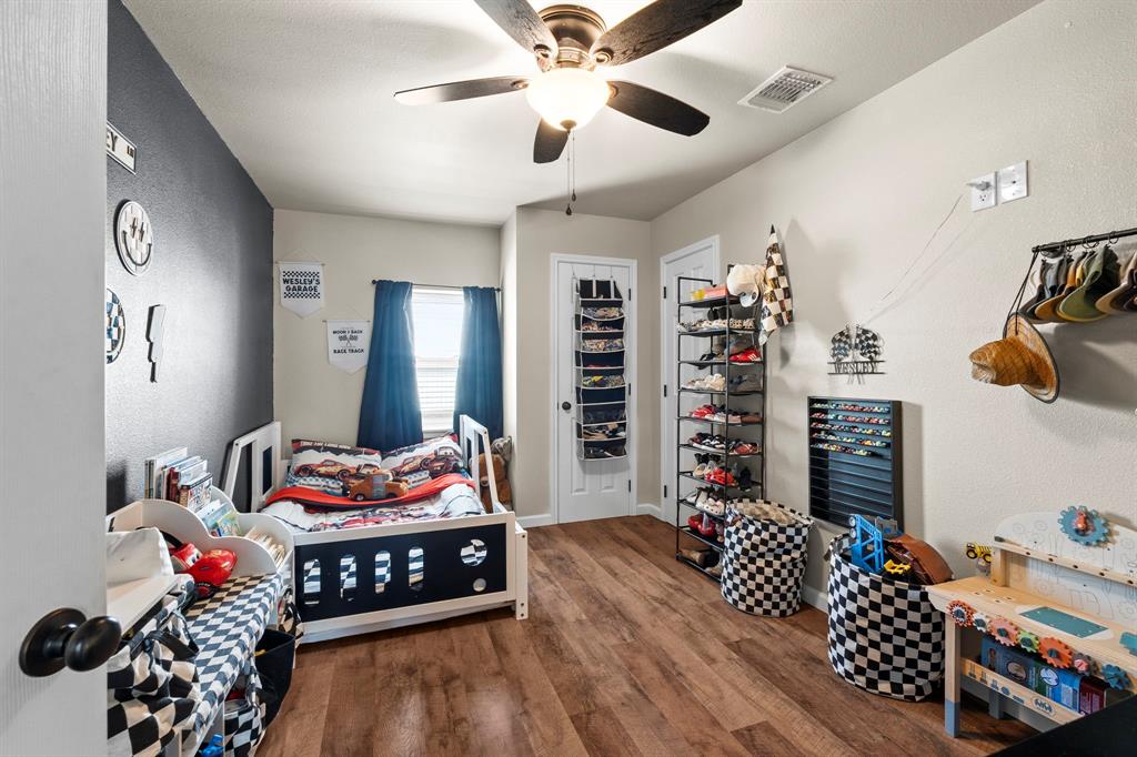 1404 McConnell Road Gunter, TX 75058 - Photo 13 of 27 a bedroom with furniture and a chandelier