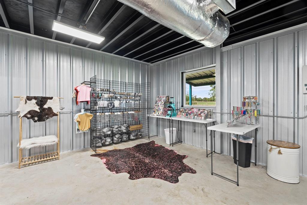 1404 McConnell Road Gunter, TX 75058 - Photo 21 of 27 a room with lots of white furniture a chandelier and a wooden floor