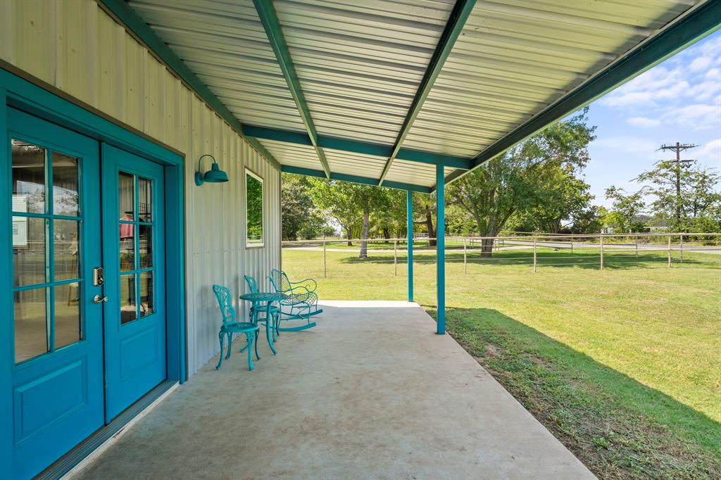 1404 McConnell Road Gunter, TX 75058 - Photo 5 of 27 a view of a swimming pool with a table and chairs under an umbrella