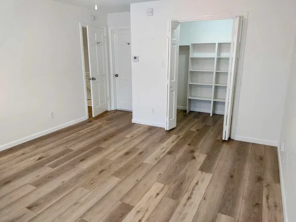 a view of a room with wooden floor and closet