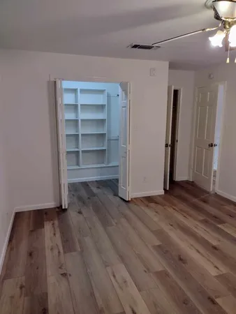 a view of a room with wooden floor and closet