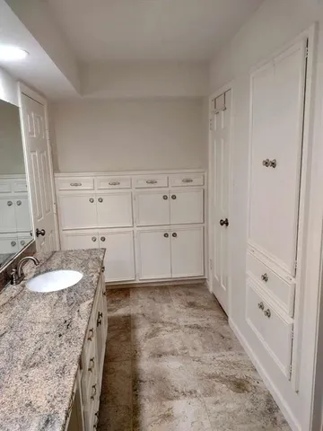 a front view of a house with a yard and potted plants