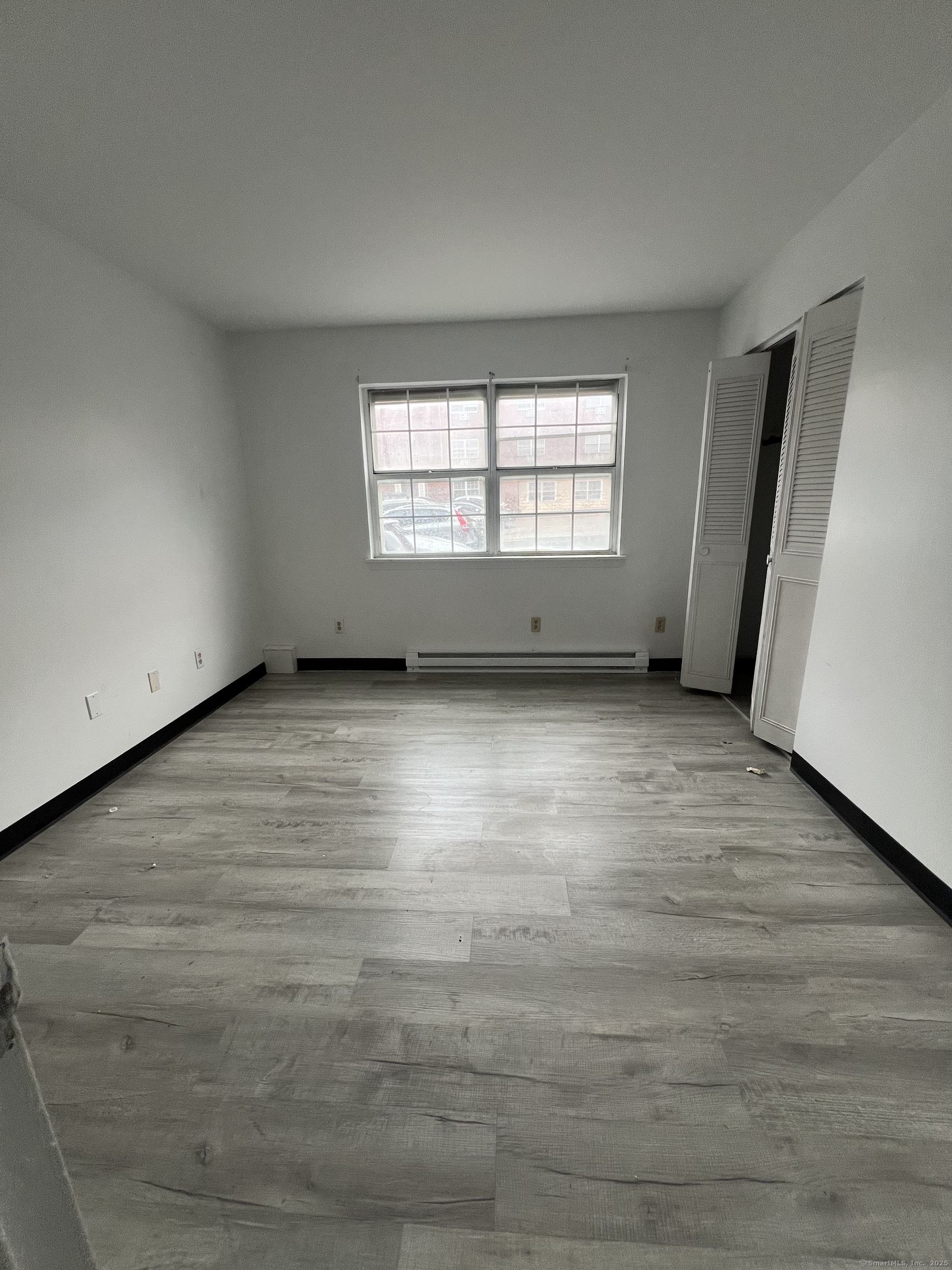 360 Palisade Avenue, Unit B09 Bridgeport, CT 06610 - Photo 5 of 8 wooden floor in an empty room with a window