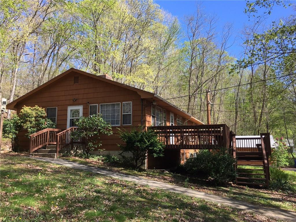 831 Phoenixville Road Chaplin, CT 06235 - Photo 1 of 1 a front view of a house with garden