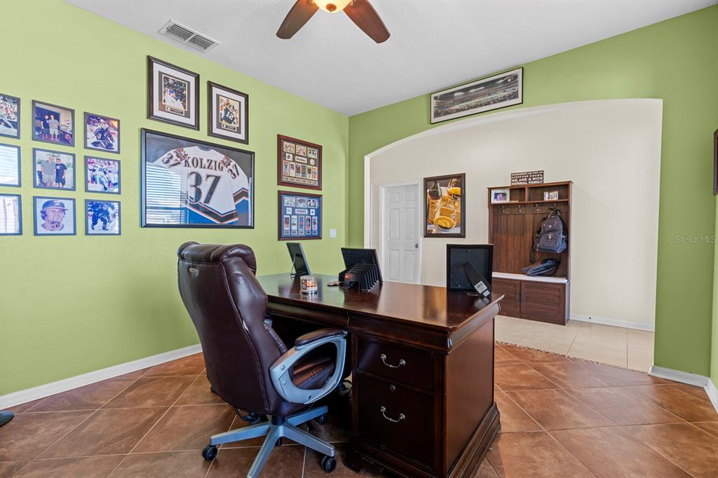 159 Star Shell Drive Apollo Beach, FL 33572 - Photo 19 of 57 a view of a workspace with furniture and a bookshelf