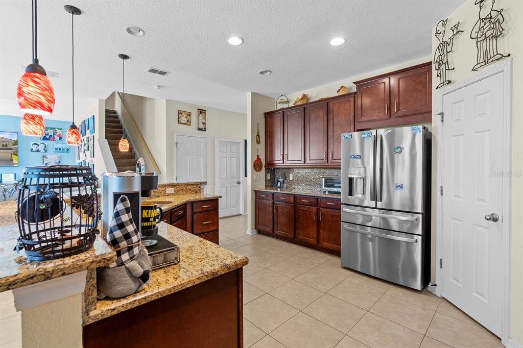 159 Star Shell Drive Apollo Beach, FL 33572 - Photo 21 of 57 a kitchen with stainless steel appliances granite countertop a refrigerator stove and sink