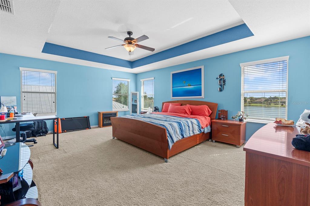 159 Star Shell Drive Apollo Beach, FL 33572 - Photo 44 of 57 a bedroom with a bed and a chandelier