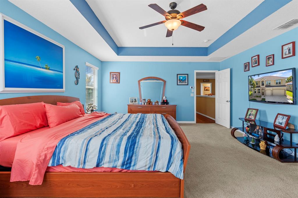 159 Star Shell Drive Apollo Beach, FL 33572 - Photo 46 of 57 a bedroom with a bed and a chandelier