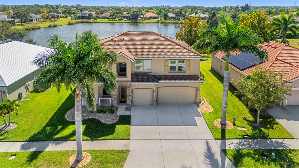 159 Star Shell Drive Apollo Beach, FL 33572 - Photo 5 of 57 a aerial view of a house with swimming pool and lake view