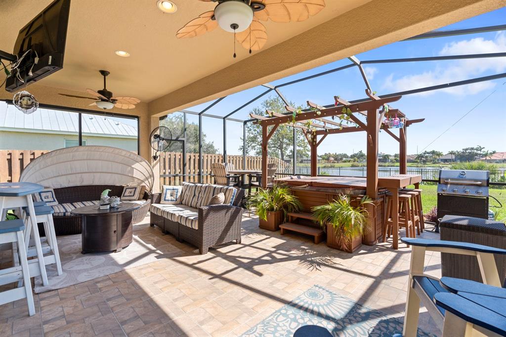 159 Star Shell Drive Apollo Beach, FL 33572 - Photo 53 of 57 a view of a patio with couches and chairs under an umbrella