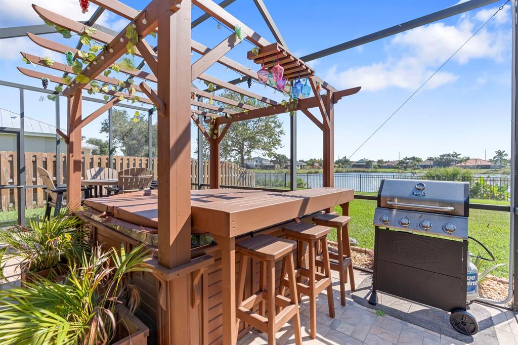 159 Star Shell Drive Apollo Beach, FL 33572 - Photo 55 of 57 a view of a patio with table and chairs with wooden floor and fence
