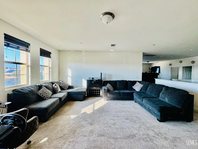 a living room with furniture and potted plant