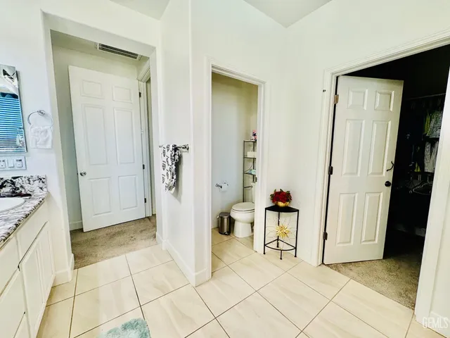 a view of the patio with table and chairs potted plants with wooden floor