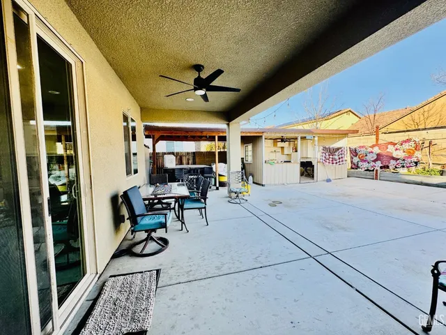 a view of a swimming pool with a lawn chairs under an umbrella