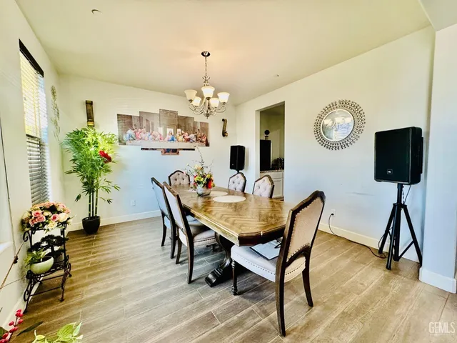 a view of a dining room with furniture wooden floor and chandelier