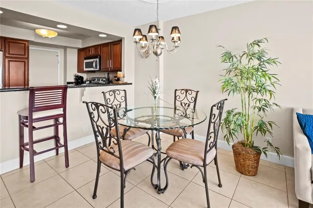 a view of a dining room with furniture and a potted plant