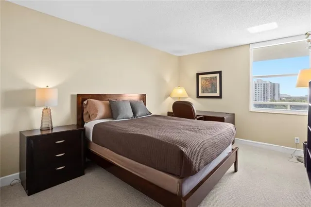 a bedroom with a bed and a night stand