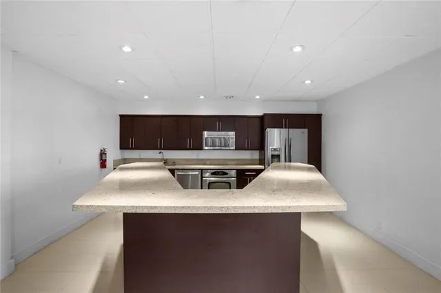 a large kitchen with stainless steel appliances a sink and a stove