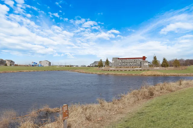 a porch with a table and chairs under an umbrella
