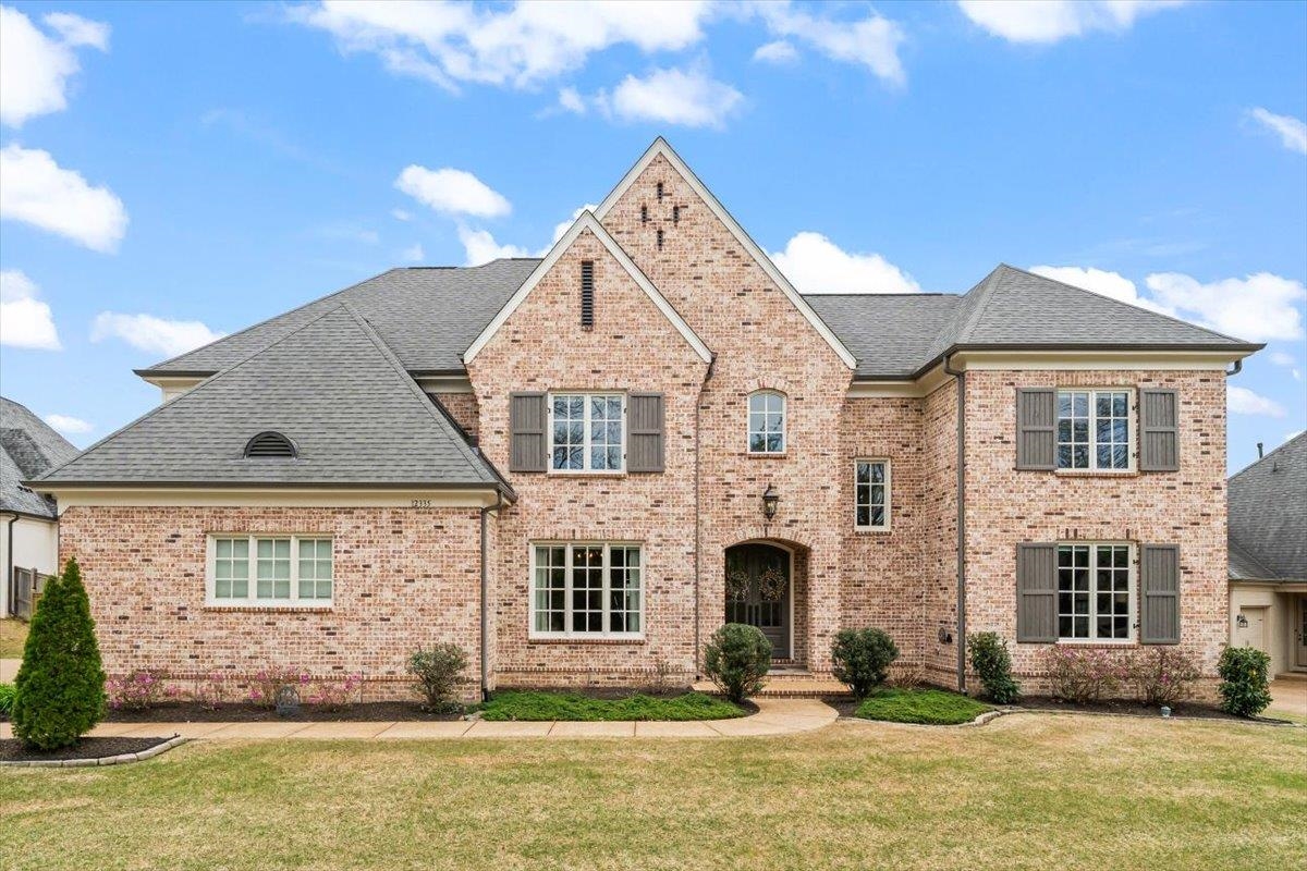 a front view of a house with a yard