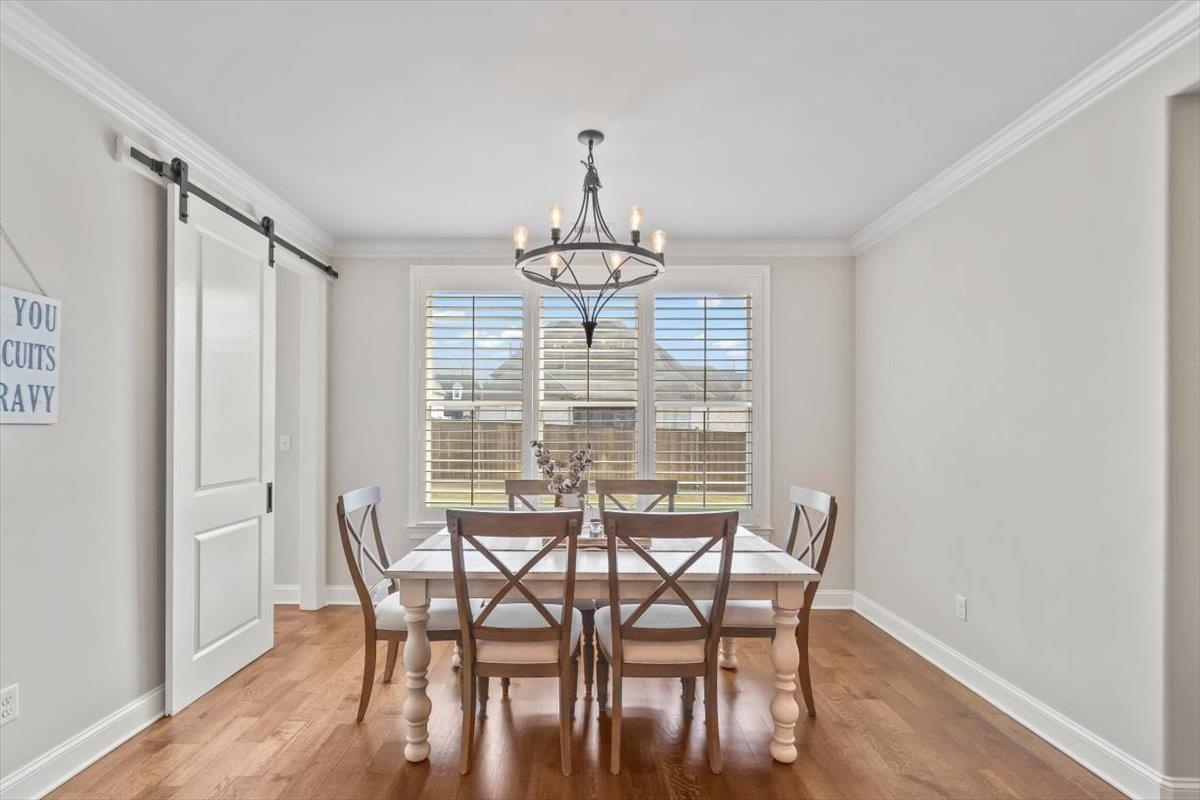 12335 Cascabel Lane Collierville, TN 38017 - Photo 13 of 38 a view of a dining room with furniture window and wooden floor