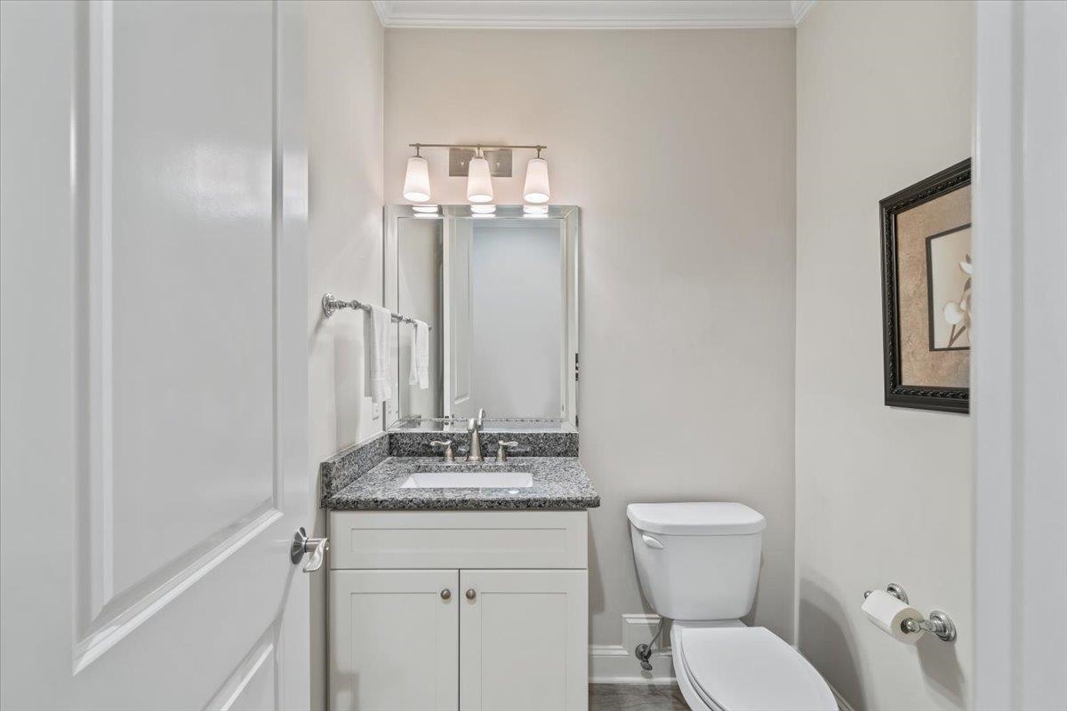 12335 Cascabel Lane Collierville, TN 38017 - Photo 15 of 38 a bathroom with a toilet a sink and mirror