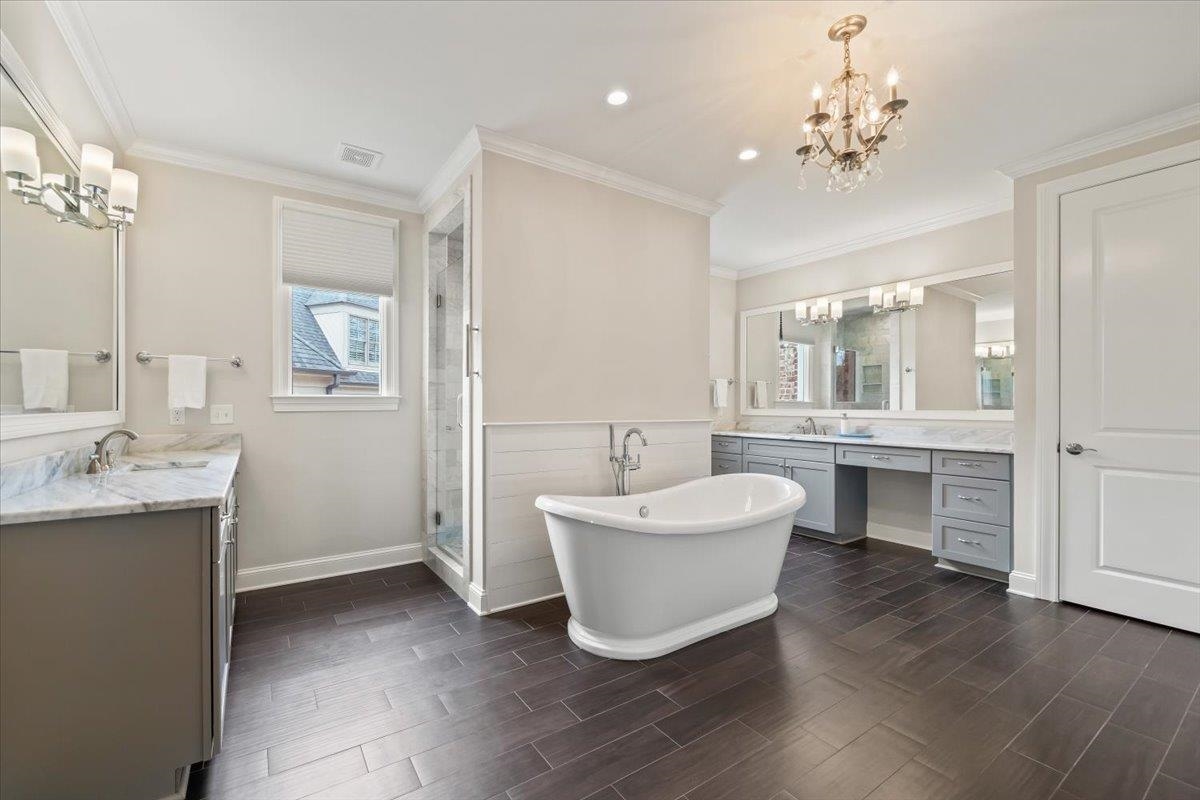 12335 Cascabel Lane Collierville, TN 38017 - Photo 18 of 38 a bathroom with a double vanity sink mirror and bathtub
