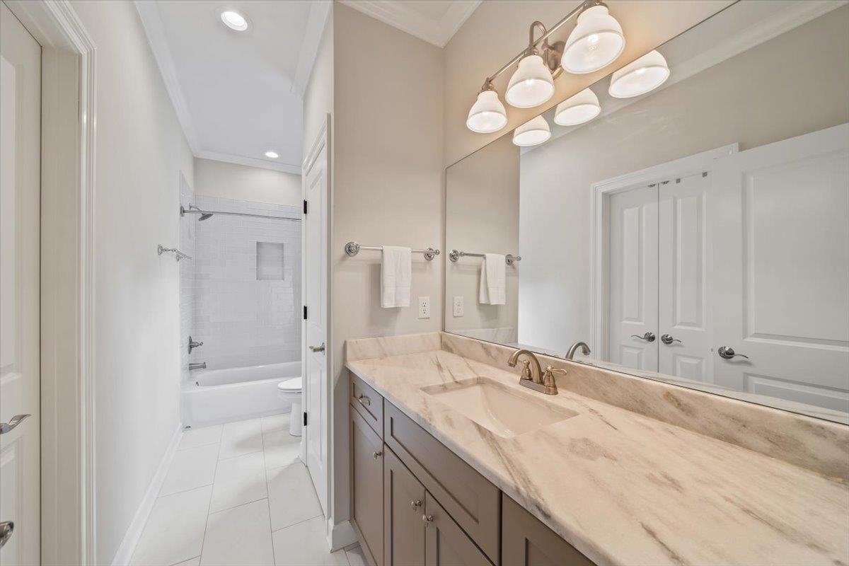 12335 Cascabel Lane Collierville, TN 38017 - Photo 24 of 38 a bathroom with a granite countertop sink mirror and a shower