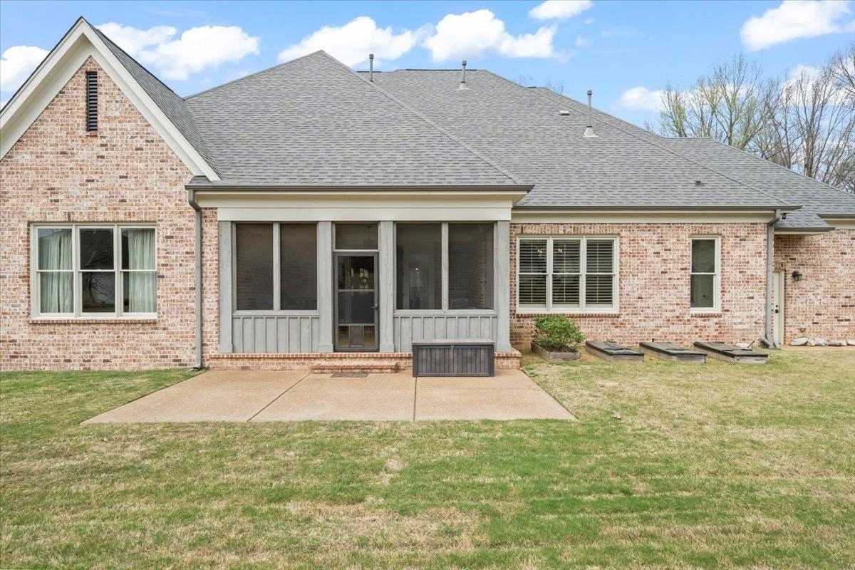 12335 Cascabel Lane Collierville, TN 38017 - Photo 32 of 38 a front view of a house with a garden and yard