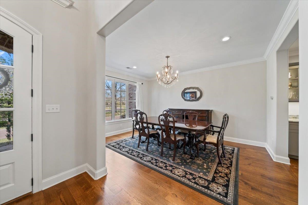 12335 Cascabel Lane Collierville, TN 38017 - Photo 5 of 38 a view of a dining room with furniture and wooden floor