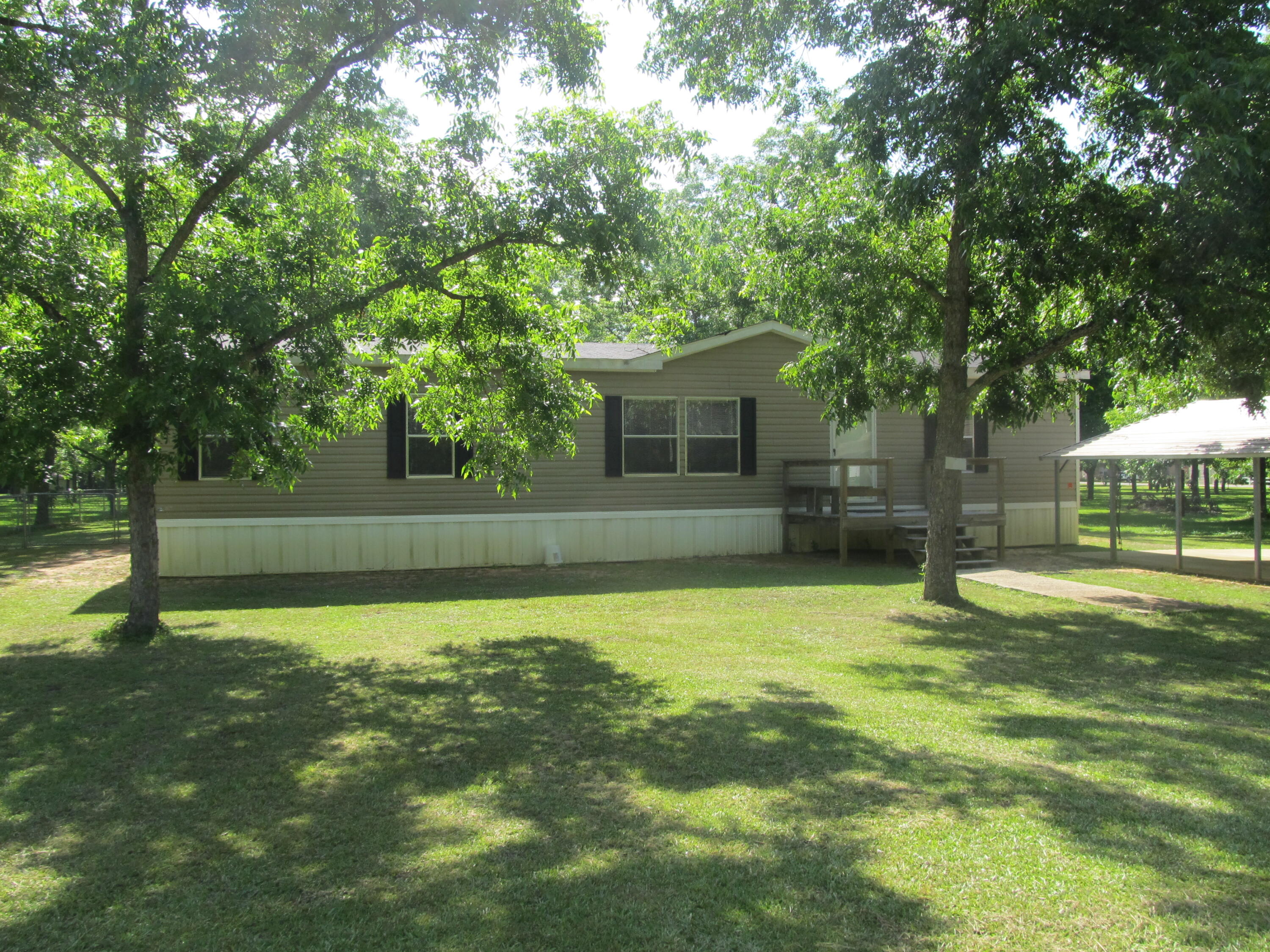 32114 Office Road Dozier, AL 36028 - Photo 1 of 24 a backyard of a house with lots of green space