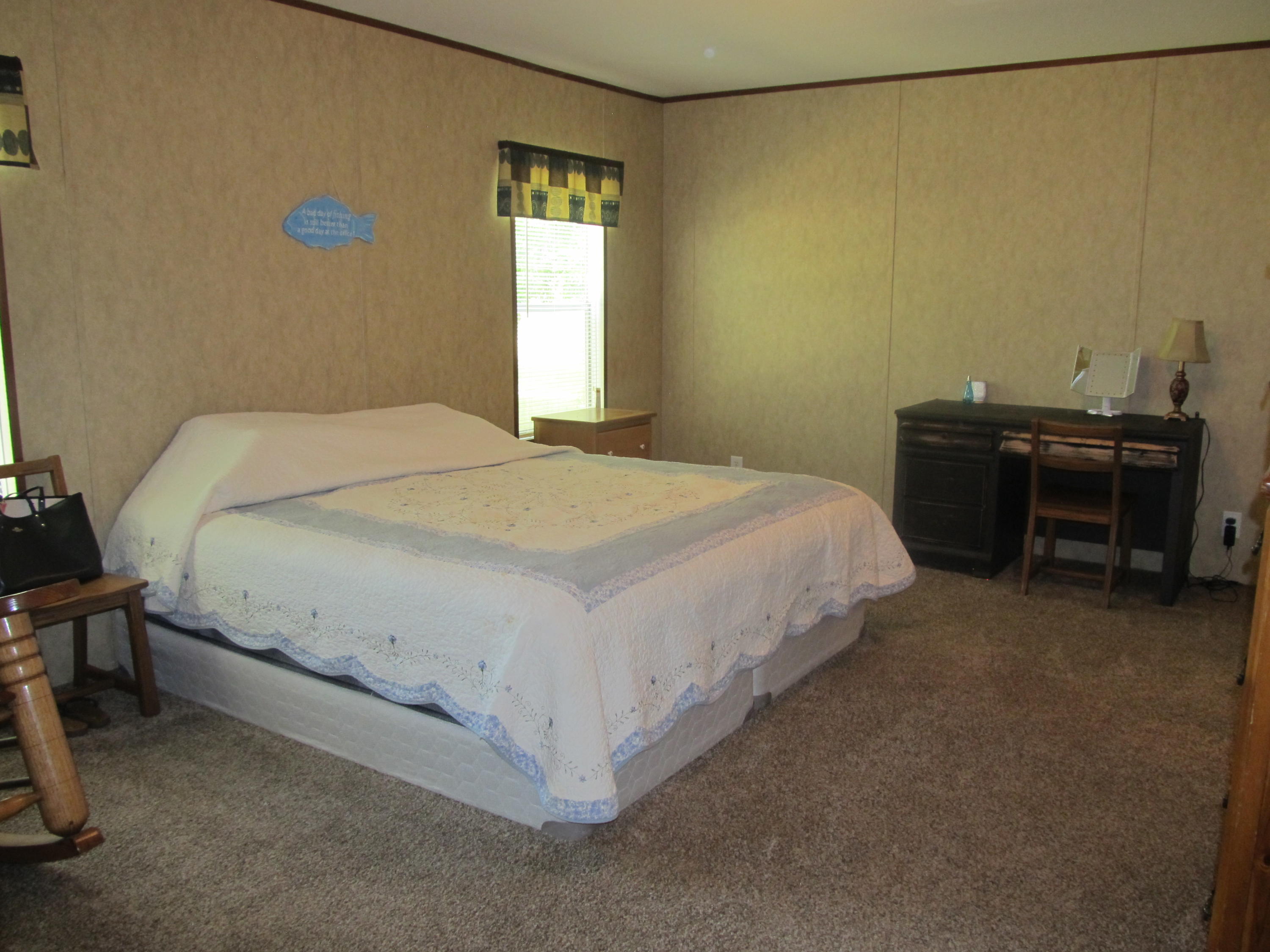 32114 Office Road Dozier, AL 36028 - Photo 12 of 24 a bedroom with a bed and a table in it