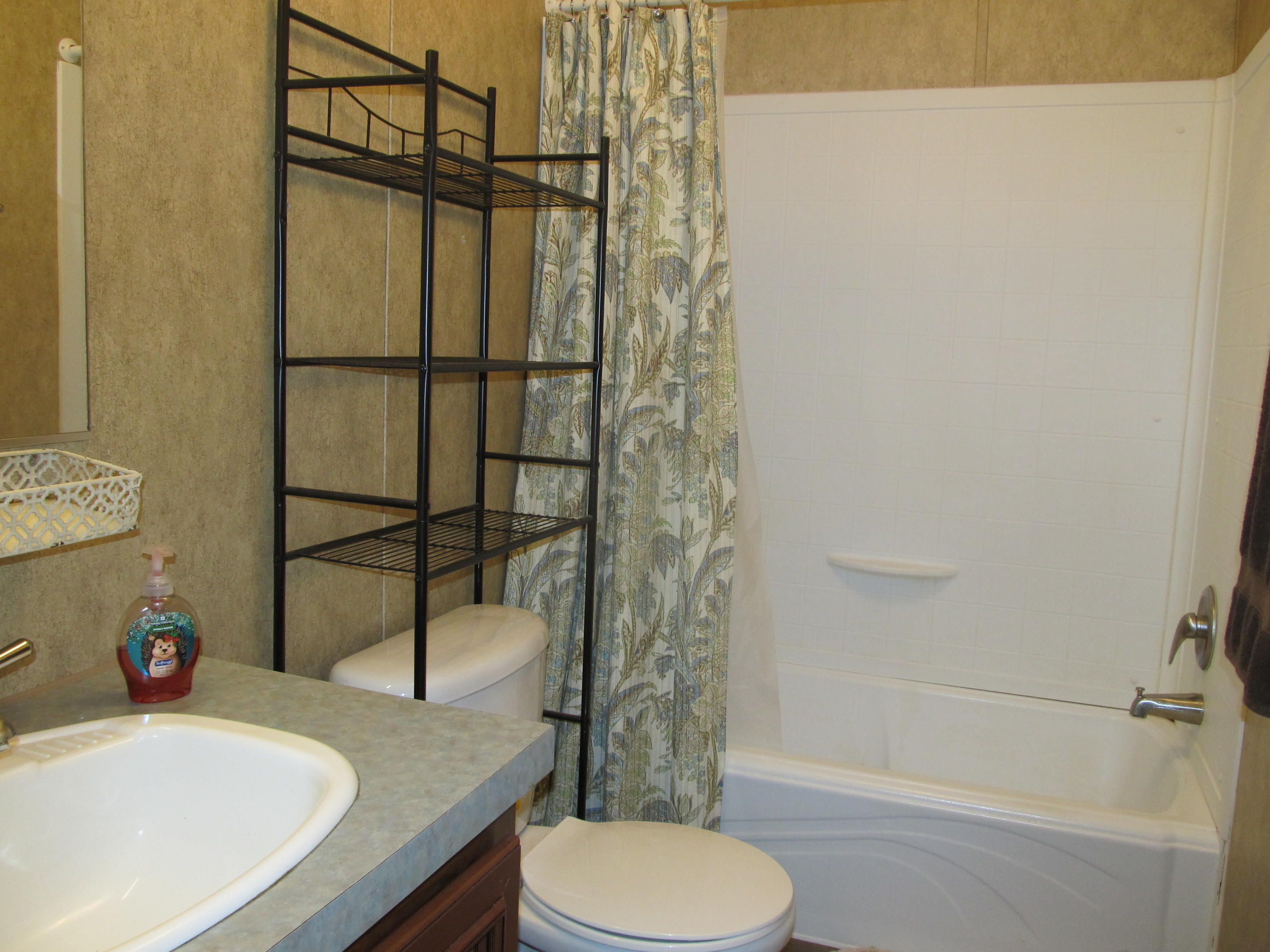 32114 Office Road Dozier, AL 36028 - Photo 13 of 24 a bathroom with a sink toilet and shower