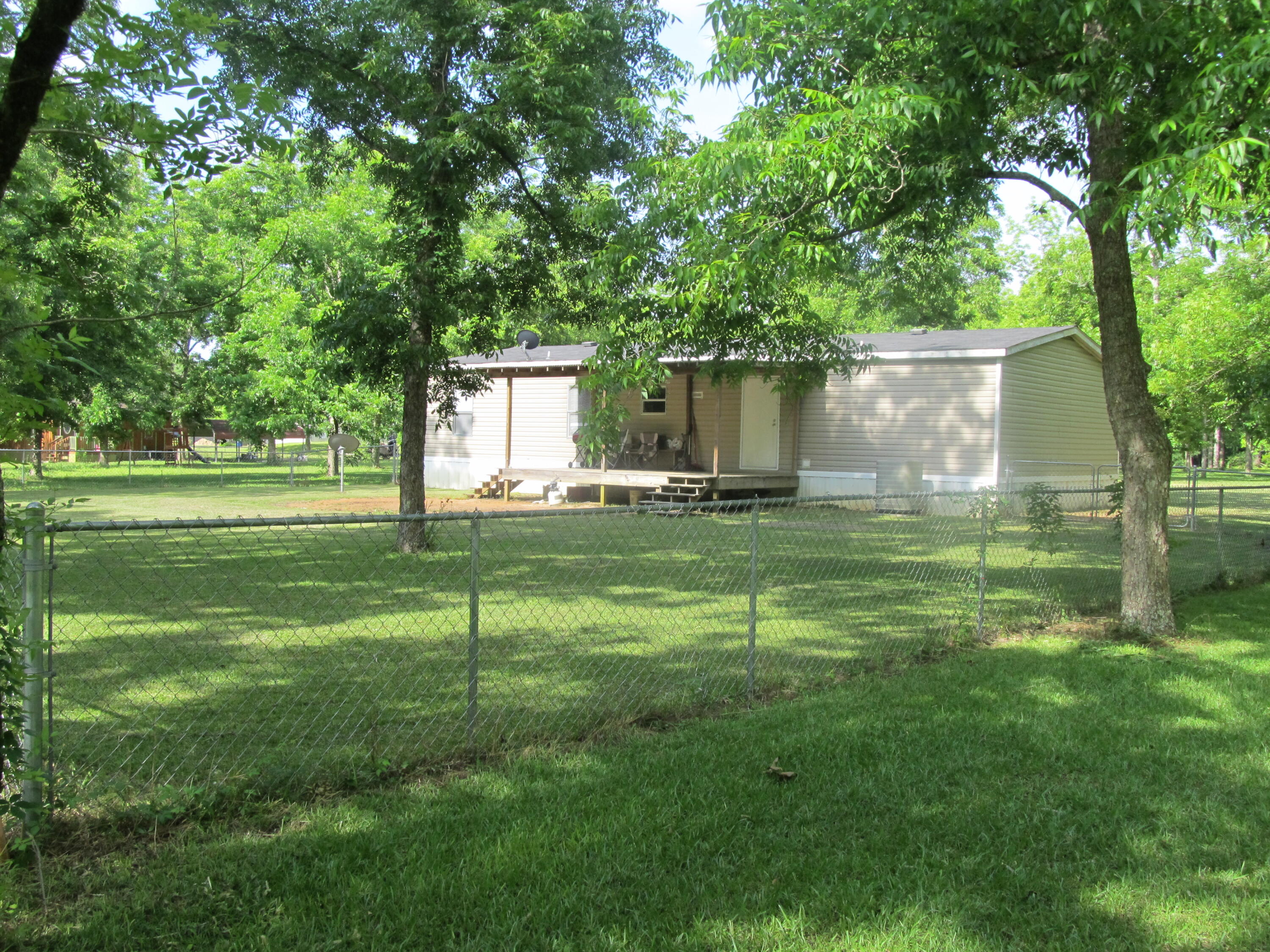 32114 Office Road Dozier, AL 36028 - Photo 21 of 24 a backyard of a house with lots of green space and fountain