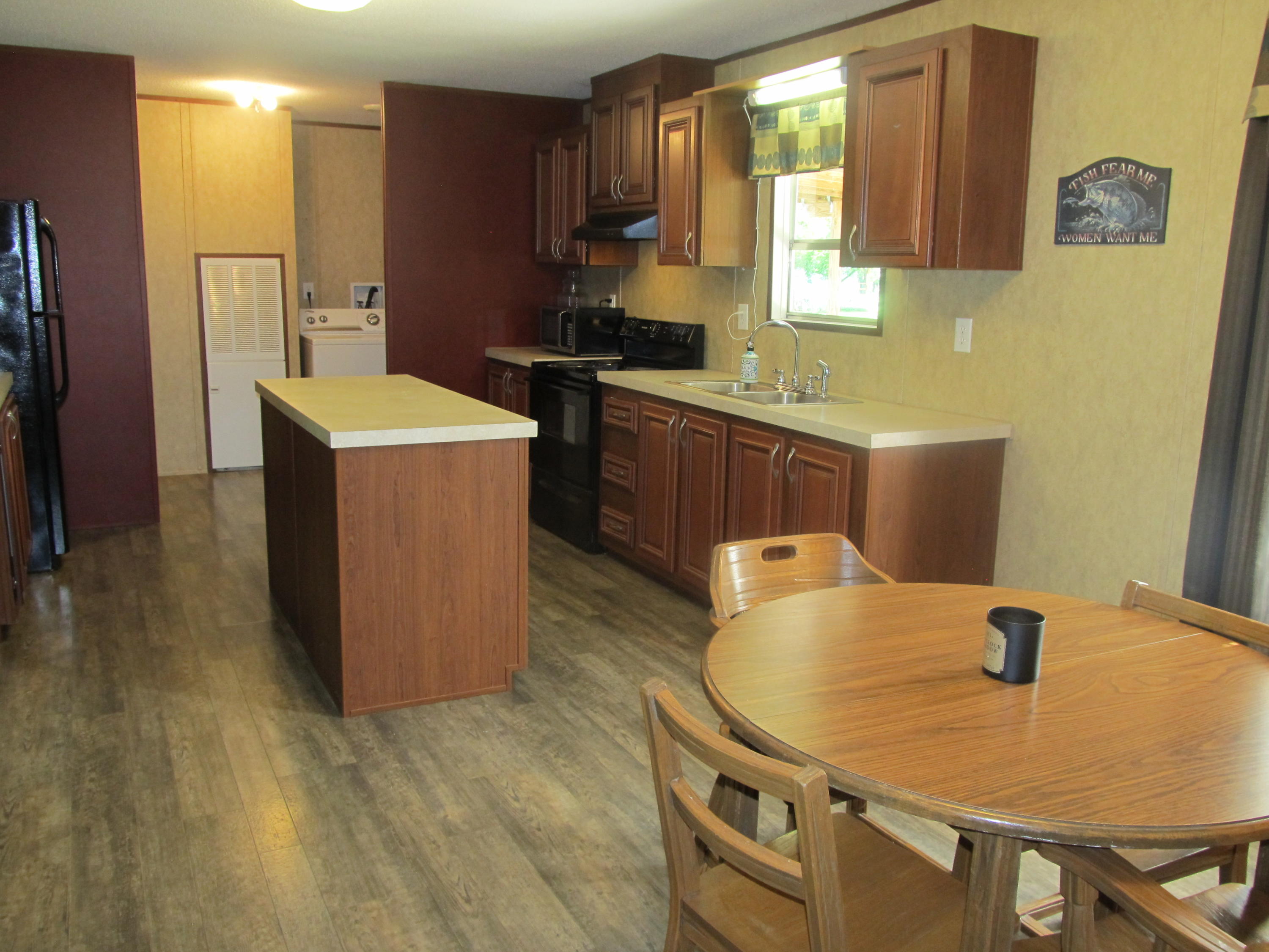 32114 Office Road Dozier, AL 36028 - Photo 7 of 24 a kitchen with sink a refrigerator and wooden cabinets