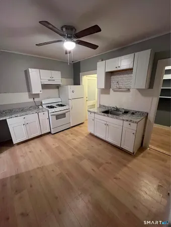 a kitchen with stainless steel appliances granite countertop a stove and a sink