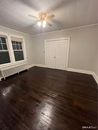wooden floor in an empty room with a window