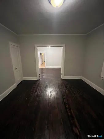 a view of wooden floor and a window in a room