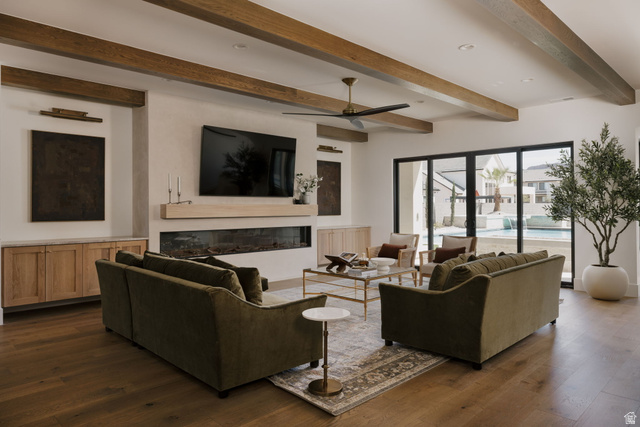 2281 South Crimson Cliffs Way St. George, UT 84790 - Photo 21 of 47 Living room with a glass covered fireplace, ceiling fan, beam ceiling, dark wood finished floors, and recessed lighting